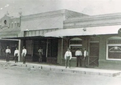 Brick storefronts fronted by new concrete sidewalks.