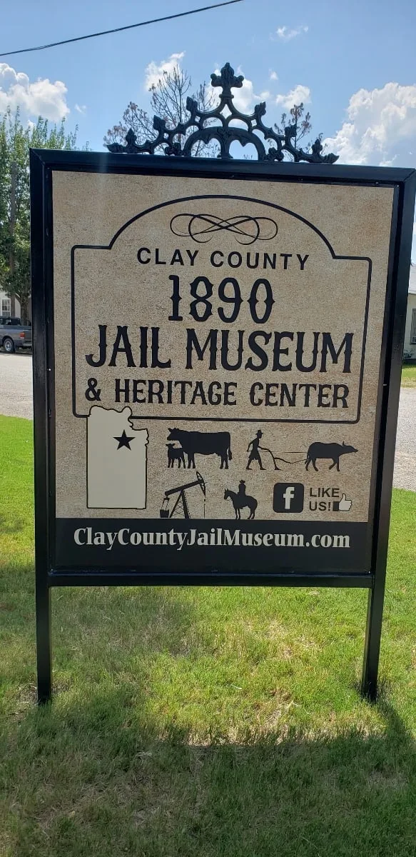 The new museum sign standing in the lawn, read straight on: “Clay County 1890 Jail Museum & Heritage Center.”